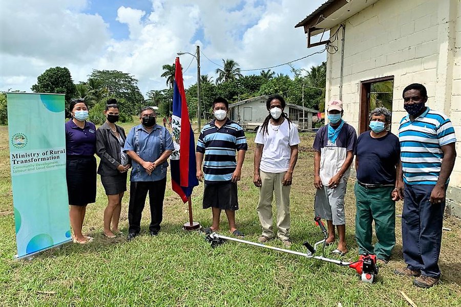 HANDING OVER WEED EATER MORE TOMORROW VILLAGE